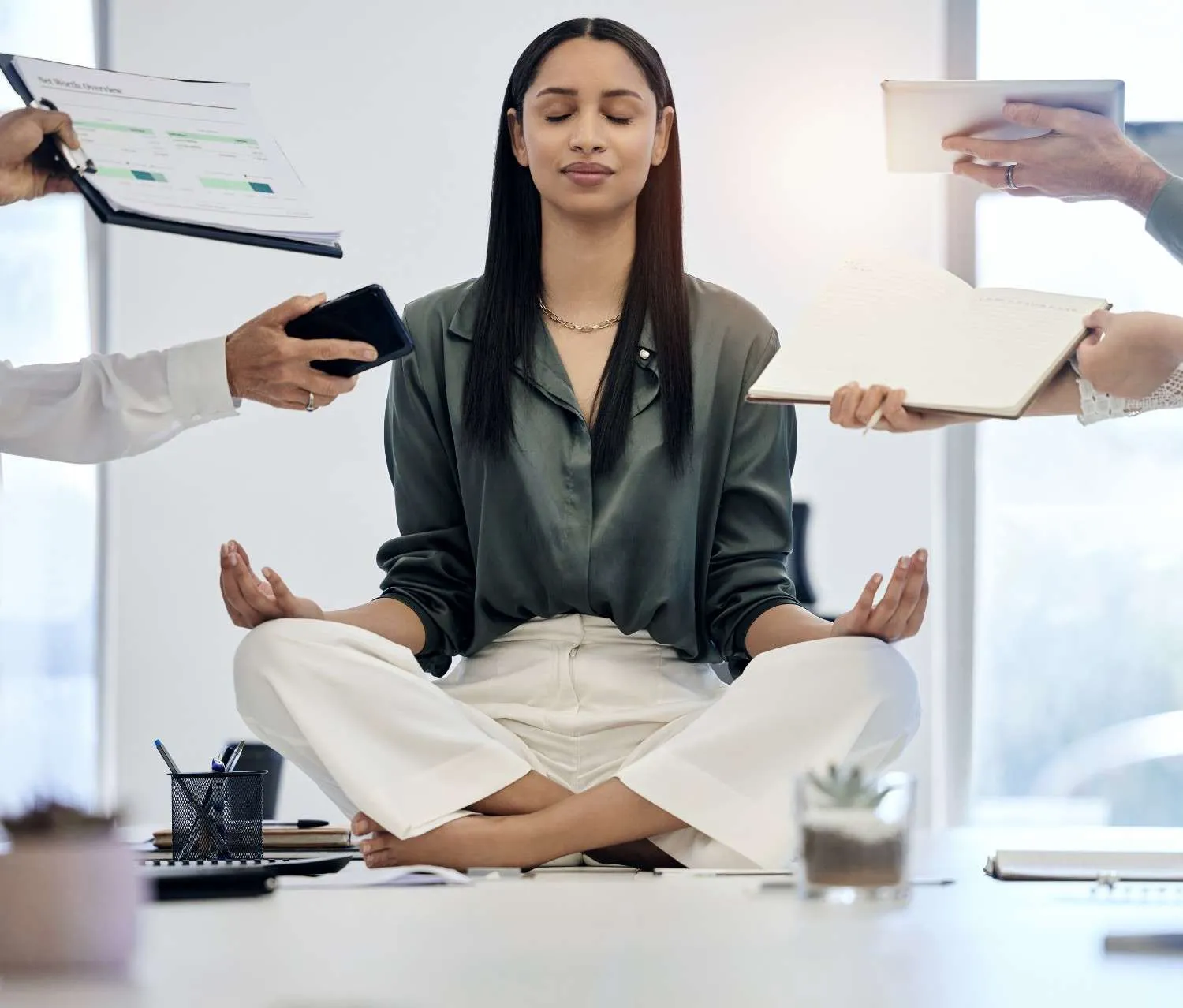 A woman staying calm while work is pushed at her from every side