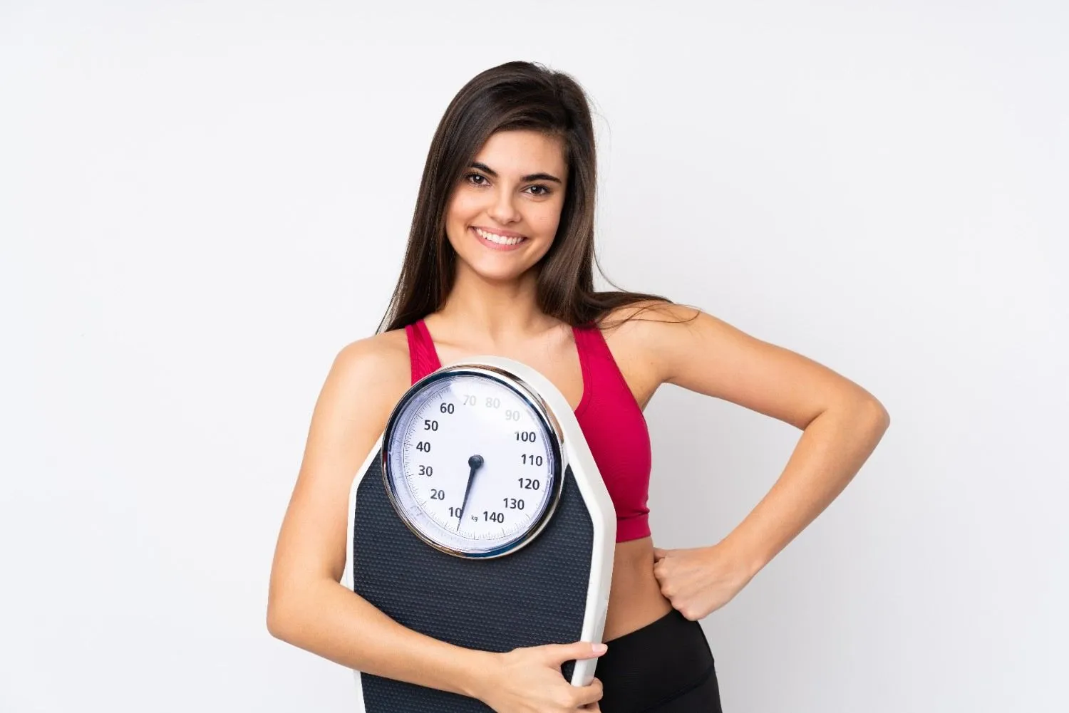 A woman holding a bathroom scale